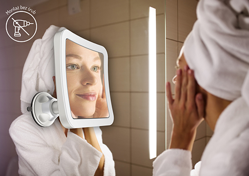 Woman looking on her mirror in bathroom