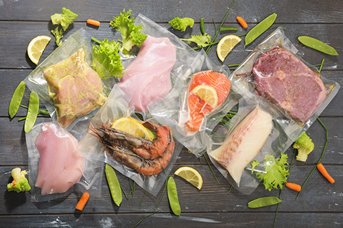 Sous Vide cooking concept. Vacuum packed ingredients arranged on